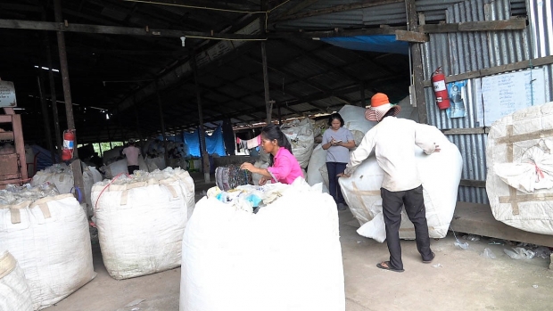 After collection from the community, Ms. Suree oversees packing of recyclable waste at her facility.