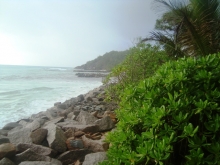 The Anse Kerlan coastline in Praslin, Seychelles now lined with rock armouring to protect from erosion.