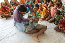 Children demonstrate basic first aid techniques for use in disaster situations