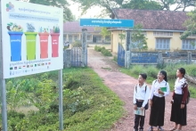 Signboard with primary school students in Tuol Torteung commune