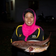 Fish for my family. A woman showing the large fish her husband catched in the morning. The community in Ban Nam Rab is now more aware of the important ecosystem services mangroves provide, among which ensuring food