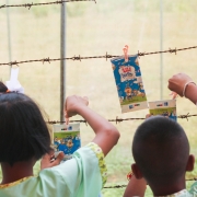 Elementary school students in Mairood hang rinsed milk cartons to dry before recycling