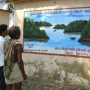 Local community members read through the mangrove awareness banner designed under this SGP