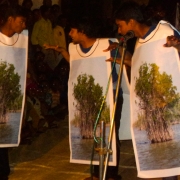 Actors, representing mangrove trees, ponder their fate 