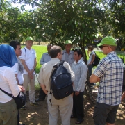 RSC-11 participants listen to a community member during visit to polders in Sihanoukville.