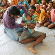 Children demonstrate basic first aid techniques for use in disaster situations