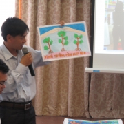 Secondary school teacher presenting pupil's drawing on mangroves conservation