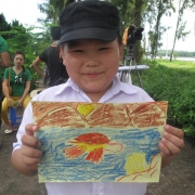 A secondary student in Co To island happy with his marine turtle picture during drawing competition
