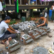 Nyan Lin Aung (left) making fuel-efficient stoves