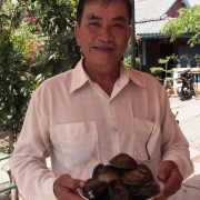 Bui Thanh Cong, shrimp farmer from Tra Vinh, Viet Nam, showing clams harvested from his farm.