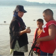 Women mentoring youth on traditional food found in mangrove mudflats 