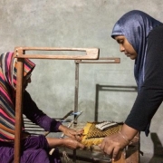 Leena (right) trains others in advanced mat weaving