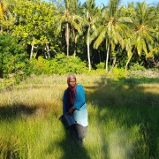 Reed farmer applying ash to her reed field.