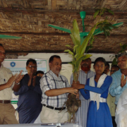 A student from Hnila Girl's High School accepts a sapling from Khursid Alam (CODEC) and Ishtiaq Uddin Ahmad (IUCN)
