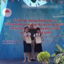 NCB Chair presenting awards to second prize winners of mangroves painting contest