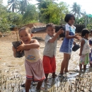 Kids planting mangroves 