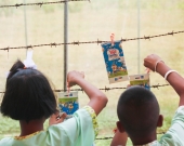 Elementary school students in Mairood hang rinsed milk cartons to dry before recycling