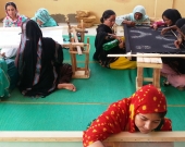 Collective effort by women on completing hand embroidery orders in Kakapir, Karachi, Pakistan