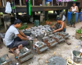 Nyan Lin Aung (left) making fuel-efficient stoves