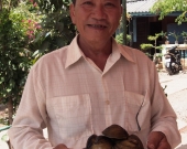 Bui Thanh Cong, shrimp farmer from Tra Vinh, Viet Nam, showing clams harvested from his farm.