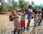Kids planting mangroves 
