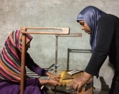 Leena (right) trains others in advanced mat weaving