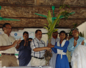 A student from Hnila Girl's High School accepts a sapling from Khursid Alam (CODEC) and Ishtiaq Uddin Ahmad (IUCN)