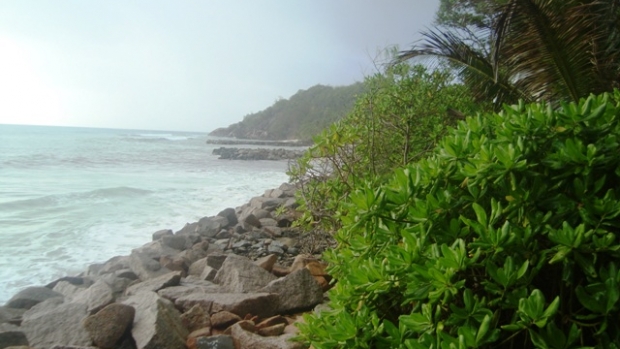 The Anse Kerlan coastline in Praslin, Seychelles now lined with rock armouring to protect from erosion.