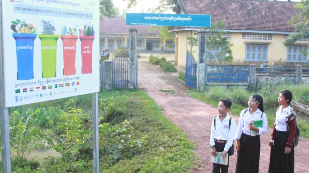 Signboard with primary school students in Tuol Torteung commune