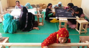 Collective effort by women on completing hand embroidery orders in Kakapir, Karachi, Pakistan