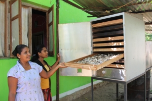 MFF project beneficiaries show off the new fish dehydrator machine