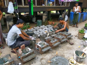Nyan Lin Aung (left) making fuel-efficient stoves