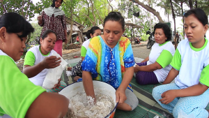 Rustima (centre) and her women's group make fish crackers