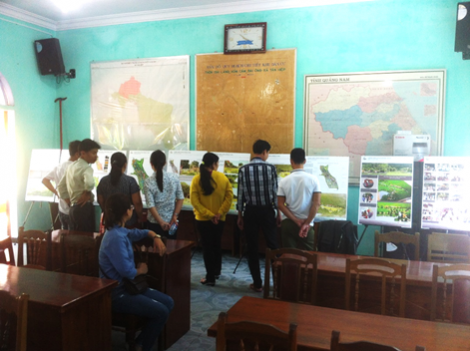 A row of several men and women read informative posters