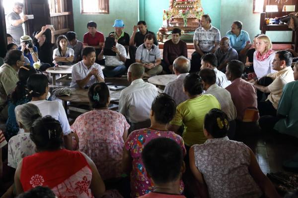MFF staff and local people sit together on the floor to talk