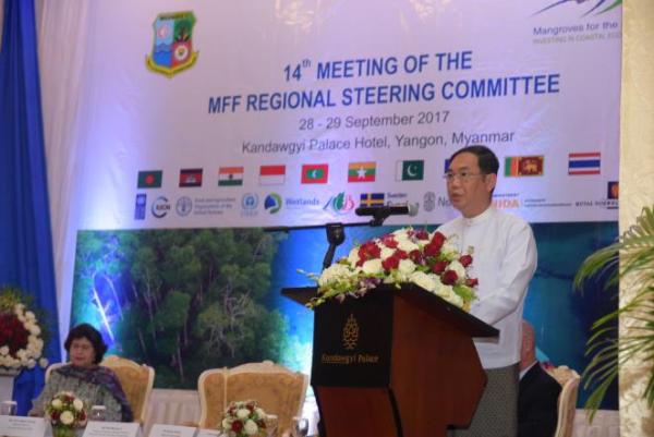 Khin Maung Ye delivers his speech onstage at a podium